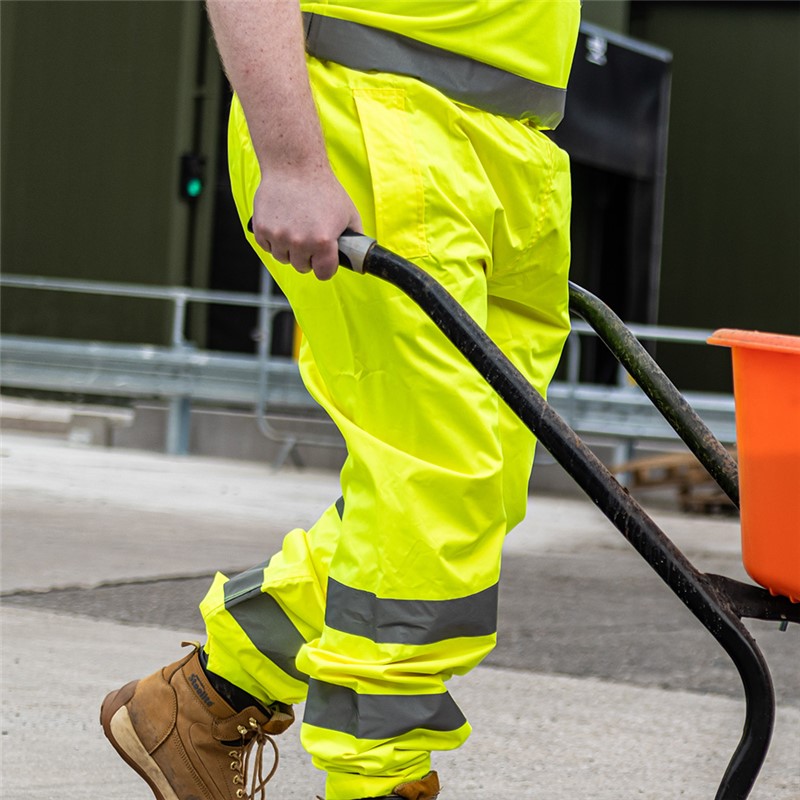 High visibility yellow waterproof over trousers with reflective tape for extra visibility. 100% polyester.

• 50mm reflective tape around both legs
• Pocket slits to allow east access to wearer&#39;s trouser pockets
• Waterproof
• Elasticated waistband
• 300D PU coated oxford 100% poly fabric &amp; high reflective poly tape